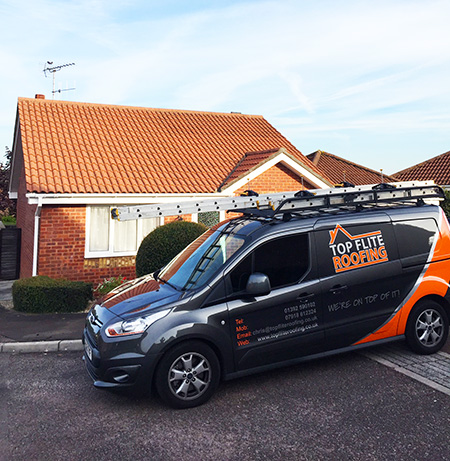 Top Flite Roofing van outside of a house with a new roof